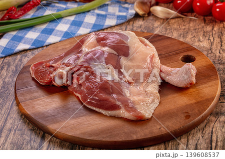 Raw Duck Leg Quarter on Rustic Wooden Board with Fresh Vegetables Raw Duck Leg Quarter on Rustic Wooden Board with Fresh Vegetables 139608537