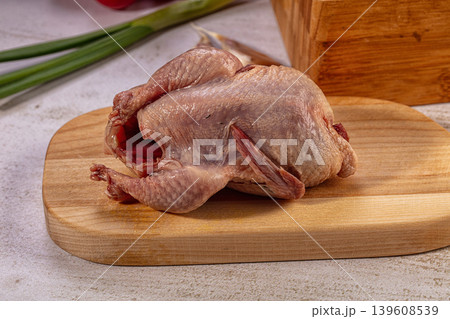 Raw Whole Quail on Wooden Board Raw Whole Quail on Wooden Board 139608539