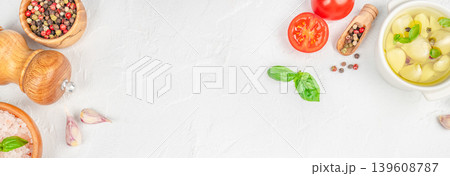 Cooking ingredients border with garlic, spices and basil on light background Cooking ingredients border with garlic, spices and basil on light background 139608787