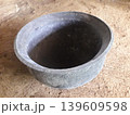 Ancient blackened clay pot for traditional roasting or frying over an open fire in Indonesia 139609598