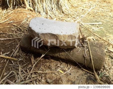Traditional Javanese stone sharpener used for sharpening sickles before gardening in Indonesia. Traditional Javanese stone sharpener used for sharpening sickles before gardening in Indonesia. 139609600