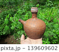 Traditional Handmade Terracotta Kendi from Java Indonesia Held by Hand 139609602