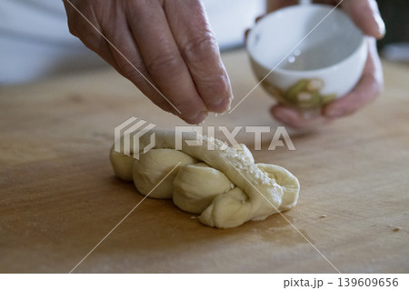 Sprinkling Sesame Seeds on Dough 139609656
