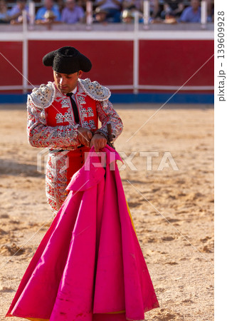 Long shot of a bullfighter keeping his knife after the bullfight	 139609928