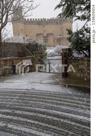 Manzanares el Real Castle in a snowy landscape, an authentic 15th century Spanish palace fortress tied to the legacy of the House of Mendoza. Manzanares el Real Castle in a snowy landscape, an authentic 15th century Spanish palace fortress tied to the legacy of the House of Mendoza. 139609954