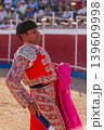 A Spanish bullfighter practices with his capote moments before the bullfight	 139609998
