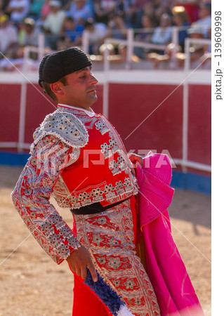 A Spanish bullfighter practices with his capote moments before the bullfight A Spanish bullfighter practices with his capote moments before the bullfight 139609998