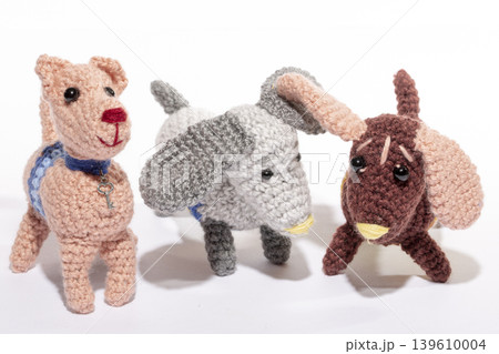 Knitted woolen dog on a white background Knitted woolen dog on a white background 139610004