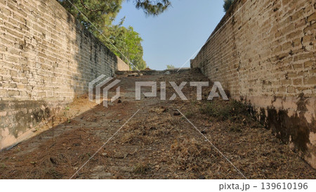 Tilla Jogian pakistan stone steps descending into ancient sacred water pond Tilla Jogian pakistan stone steps descending into ancient sacred water pond 139610196