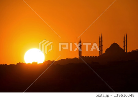 Sunset Silhouette of Istanbul Mosque. A breathtaking orange sunset behind the silhouette of a mosque and minarets on the Istanbul horizon. Perfect for travel and spirituality. Sunset Silhouette of Istanbul Mosque. A breathtaking orange sunset behind the silhouette of a mosque and minarets on the Istanbul horizon. Perfect for travel and spirituality. 139610349