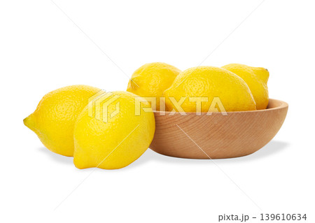 Lemons placed in a wooden bowl for use in cooking, PNG 139610634