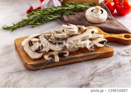 Raw champignon slices on the board Raw champignon slices on the board 139610807
