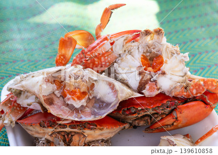 Closeup of fresh steamed crab with rich roe and juicy meat served on plate showcasing delicious seafood cuisine and coastal dining experience 139610858