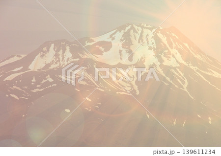 Snowy Mountain Sunrise Glow.Stunning snow-covered mountain peak glowing in sunrise light, editorial minimal style landscape highlighting natural grandeur and serene atmosphere. 139611234