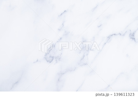 White marble slab with subtle veining on flat surface White marble slab with subtle veining on flat surface 139611323