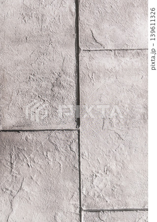 Textured stone slabs with grout lines on pale surface detail 139611326