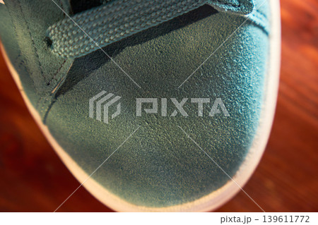 Sneaker sole stitching closeup showing welt and rubber midsole, textured suede upper and seam detail Sneaker sole stitching closeup showing welt and rubber midsole, textured suede upper and seam detail 139611772