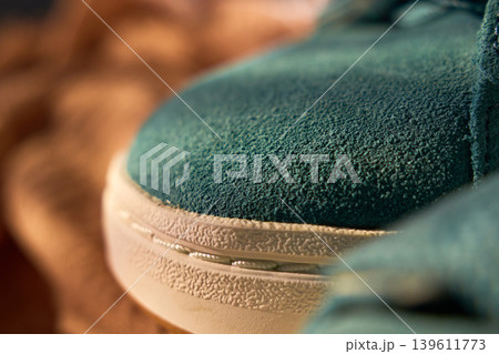 Sneaker sole stitching closeup showing welt and rubber midsole, textured suede upper and seam detail Sneaker sole stitching closeup showing welt and rubber midsole, textured suede upper and seam detail 139611773