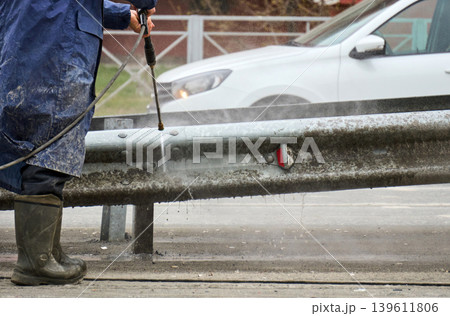 Daily city life: maintenance worker and elderly woman at a crosswalk 139611806