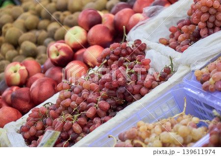 A busy market scene shows a variety of fruits for sale 139611974