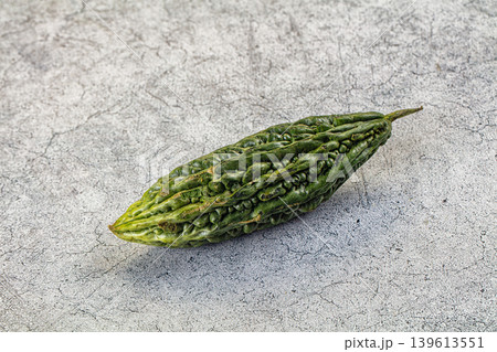 Whole bitter gourds on a dark textured slate background with copy space 139613551