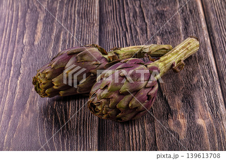 Two Fresh Purple Artichokes on Dark Rustic Wood Background 139613708