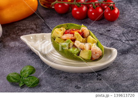 Gourmet avocado boat salad with fresh shrimp and cherry tomatoes 139613720