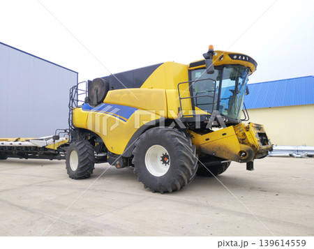 combine harvester is parked before heading out into the field to harvest crops combine harvester is parked before heading out into the field to harvest crops 139614559