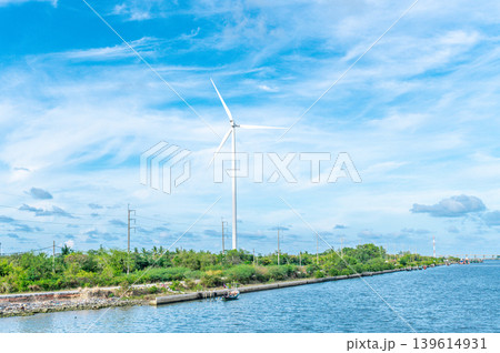 Wind Turbine for Clean Renewable Energy by the Coast under Bright Blue Sky 139614931