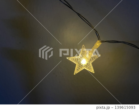 Glowing Star Shaped String Light Close Up On Dark Background Glowing Star Shaped String Light Close Up On Dark Background 139615093