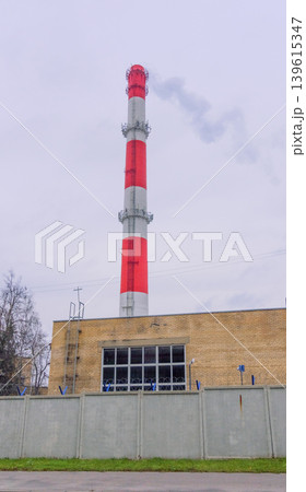 Industrial scene overview. Manufacturing plant exhibiting subdued colors and towering structures 139615347