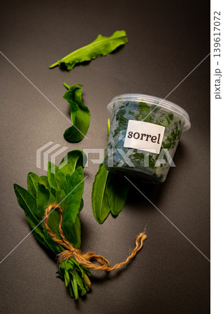 Organic sorrel bundle and fresh leaves on black backdrop 139617072