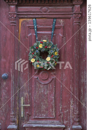 Christmas winter wreath hanging on rustic wooden door Christmas winter wreath hanging on rustic wooden door 139617626