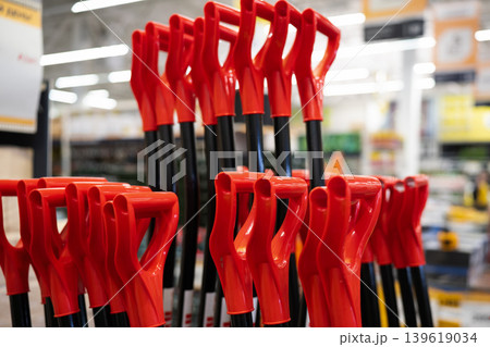Red plastic shovel handles . Close up 139619034