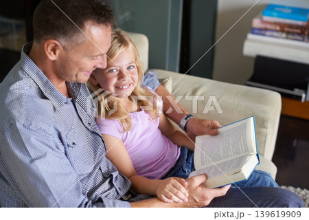 Father, child and book for storytelling at home, reading and learning fiction for education. Daddy, daughter and bonding together on couch, literacy and support for language development or knowledge 139619909