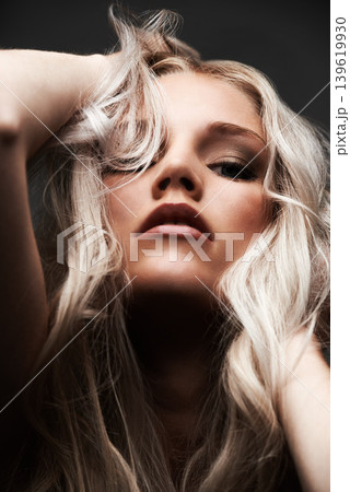 Portrait, woman and confident in studio with haircare, beauty and cosmetic with pride by gray background. Model, face and make up for glow with relax wellness and blonde hair with conditioner results Portrait, woman and confident in studio with haircare, beauty and cosmetic with pride by gray background. Model, face and make up for glow with relax wellness and blonde hair with conditioner results 139619930