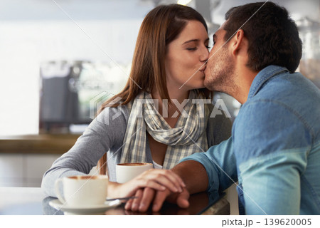 Love, kiss and couple in coffee shop, cafe and bonding together on valentines day date. Romance, man and woman in restaurant with latte drink, connection and care in healthy relationship commitment 139620005
