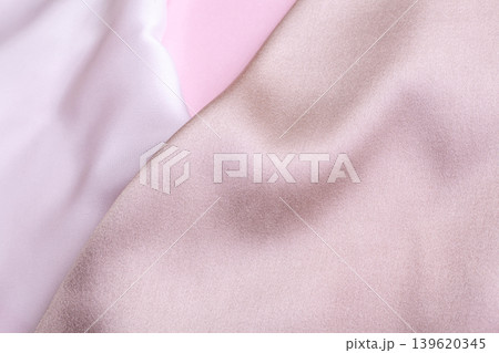 Abstract background in soft colors of silk fabrics on pink pearl paper. Beautiful trend texture 139620345