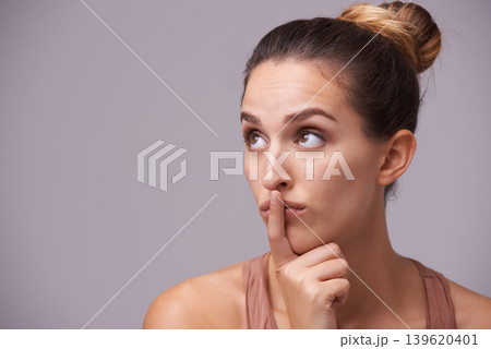 Woman thinking, touching lips or silence for secret, or privacy in gossip on grey background. Mouth, natural face or confident model isolated in studio with beauty for skincare or wellness 139620401