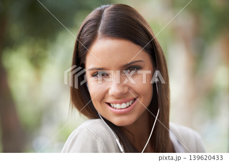 Woman, portrait and earphones for music entertainment or streaming, audio or listening. Female person, face and smile for electronic playlist sound in nature park for holiday relax, podcast or radio Woman, portrait and earphones for music entertainment or streaming, audio or listening. Female person, face and smile for electronic playlist sound in nature park for holiday relax, podcast or radio 139620433