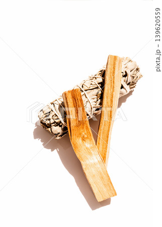 White sage bundle with two palo santo sticks on a white background White sage bundle with two palo santo sticks on a white background 139620559