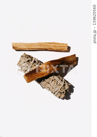White sage bundle with two palo santo sticks on a white background 139620560
