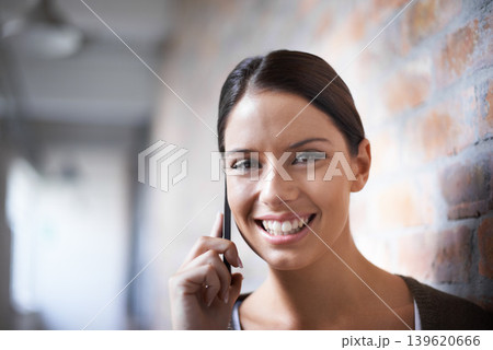 Phone call, portrait or happy woman in workplace for communication, gossip or chat by office wall. Talking, smile or face of designer listening in conversation or speaking of news, feedback or ideas Phone call, portrait or happy woman in workplace for communication, gossip or chat by office wall. Talking, smile or face of designer listening in conversation or speaking of news, feedback or ideas 139620666