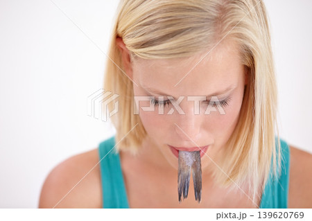 Woman, mouth and eating a fish, tail or strange food on white background of studio. Crazy, diet and person with weird seafood, cuisine and face of disgust for taste of tuna, meat or salmon mockup Woman, mouth and eating a fish, tail or strange food on white background of studio. Crazy, diet and person with weird seafood, cuisine and face of disgust for taste of tuna, meat or salmon mockup 139620769