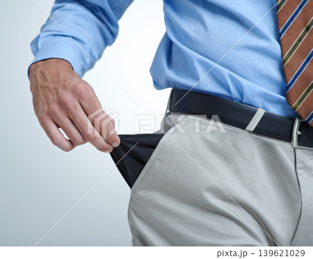 Businessperson, empty pocket and poverty in studio, unemployment and bankruptcy by white background. Closeup, no money and financial trouble or bad investment, stock market crash and poor or broke Businessperson, empty pocket and poverty in studio, unemployment and bankruptcy by white background. Closeup, no money and financial trouble or bad investment, stock market crash and poor or broke 139621029