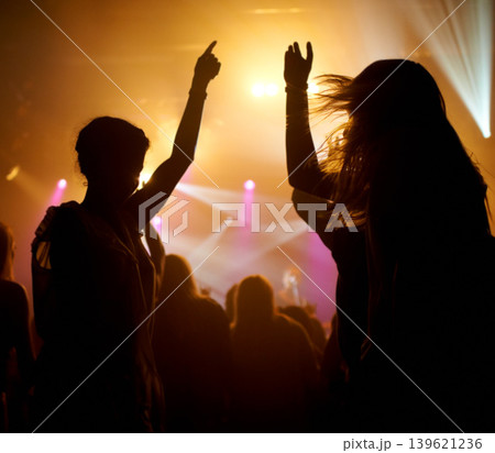 Crowd, dancing and lights concert or silhouette for live music performance or festival, rock or friends. Audience, dj and stage event for celebration rave or band sound as partying, weekend or night 139621236