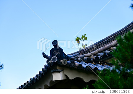 The roof of nijo jo castle, Kyoto, Japan. World Heritage Site. Roof tile pattern. Major tourist attraction in Kansai region in Japan. Japan famous historic architecture. Building exterior. The roof of nijo jo castle, Kyoto, Japan. World Heritage Site. Roof tile pattern. Major tourist attraction in Kansai region in Japan. Japan famous historic architecture. Building exterior. 139621598