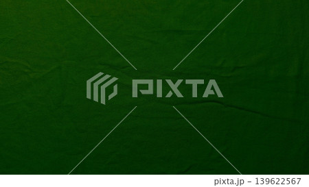 rich emerald green textured fabric closeup with deep wrinkles and dramatic dark crack rich emerald green textured fabric closeup with deep wrinkles and dramatic dark crack 139622567