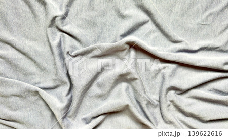 wrinkled gray fabric folds texture abstract closeup soft drapery waves minimalist neutral tones serene composition 139622616