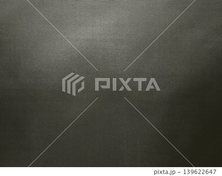 metal mesh texture with fine diagonal weave creating dark industrial background and minimal moody surface detail 139622647
